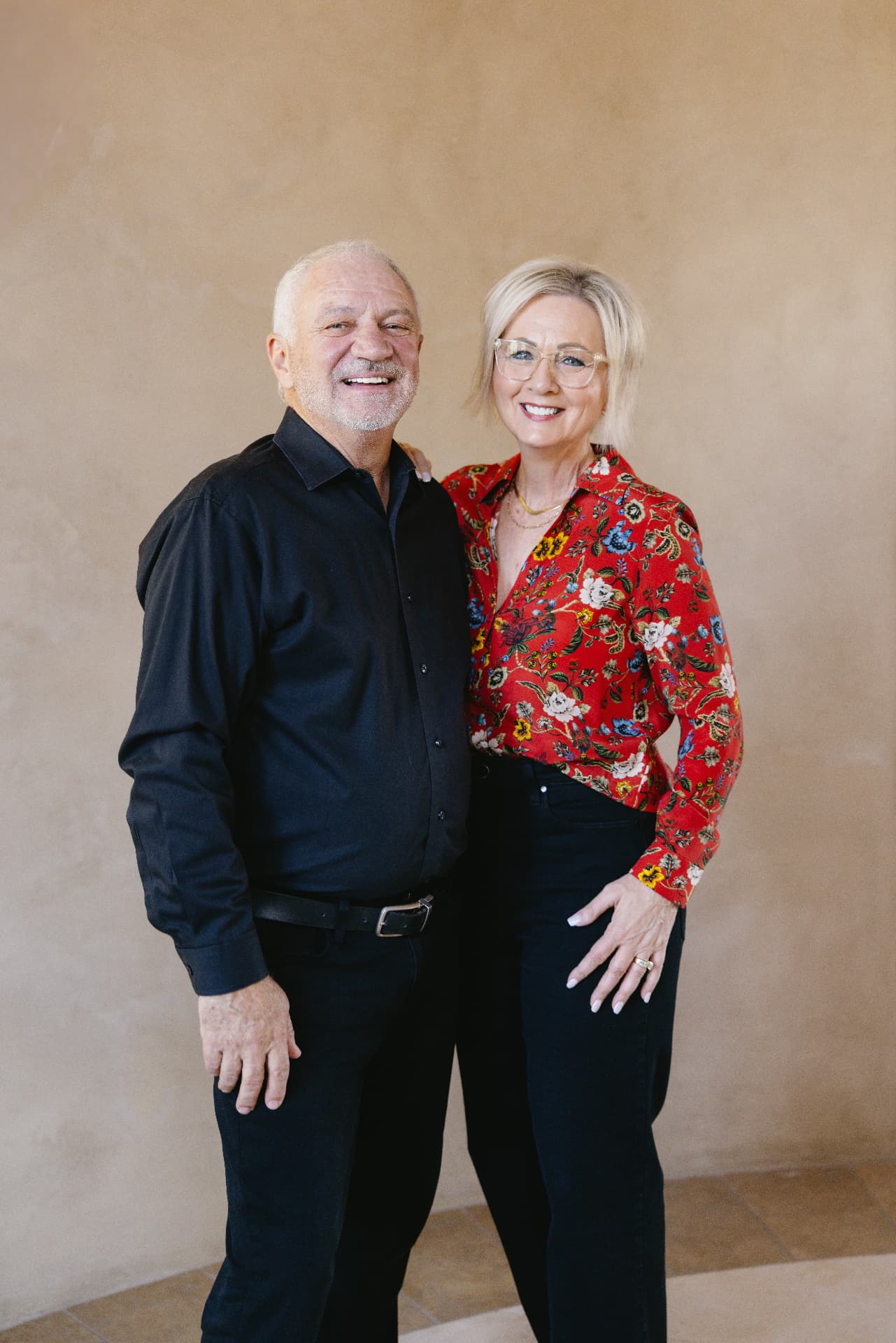 Eddie and Tammy Windsor standing together against a warm plaster wall