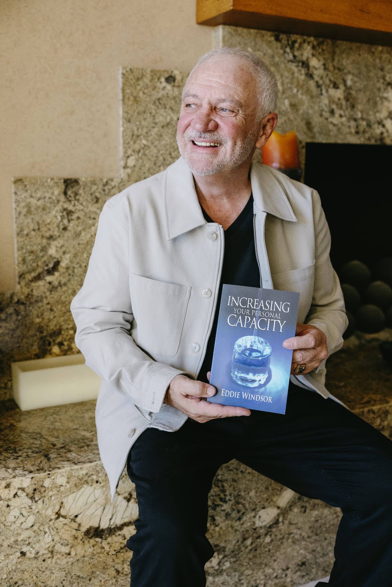 Eddie Windsor holding his book Increasing Your Personal Capacity